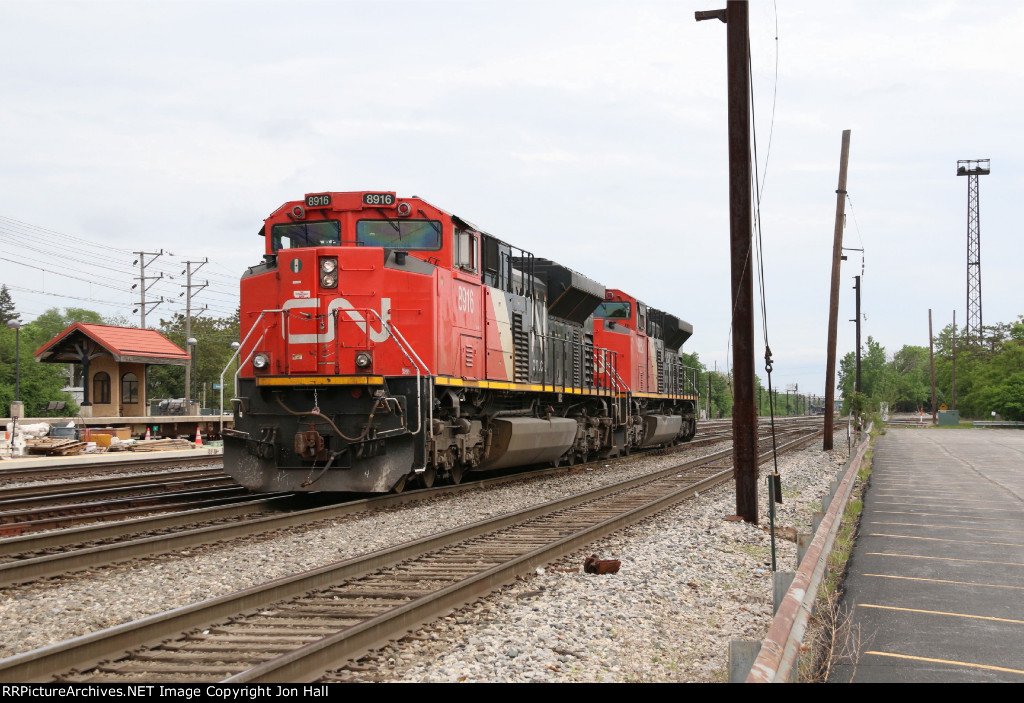 Just out of the house, the power for Q141 starts back in to the yard to build the outbound train